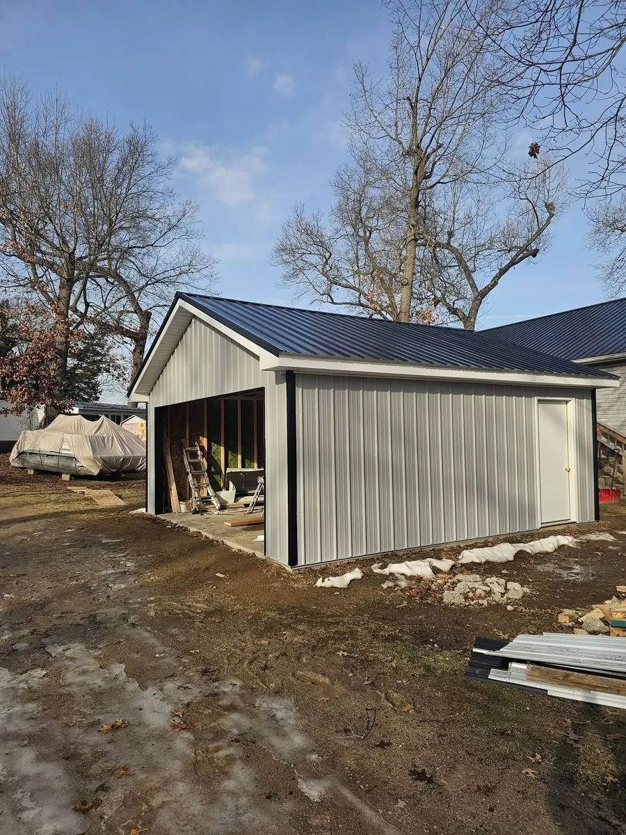 Detached garage construction with metal siding and roofing installed