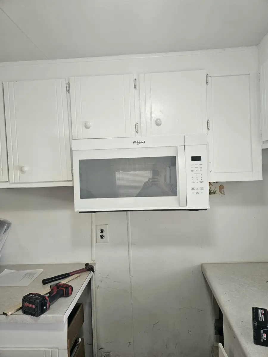 Kitchen cabinets before a KNU Services remodeling project