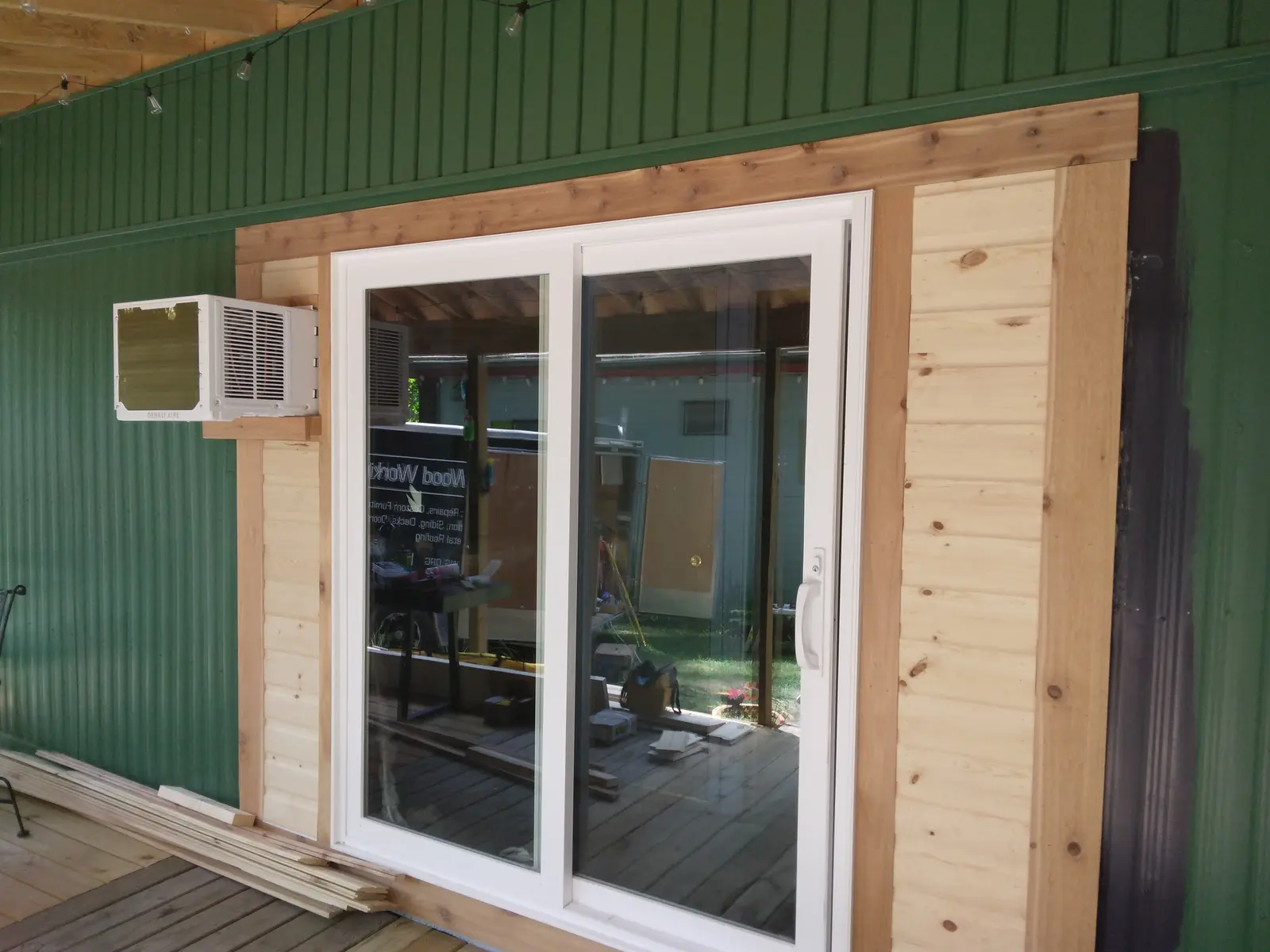 Completed white sliding patio door with custom wood trim