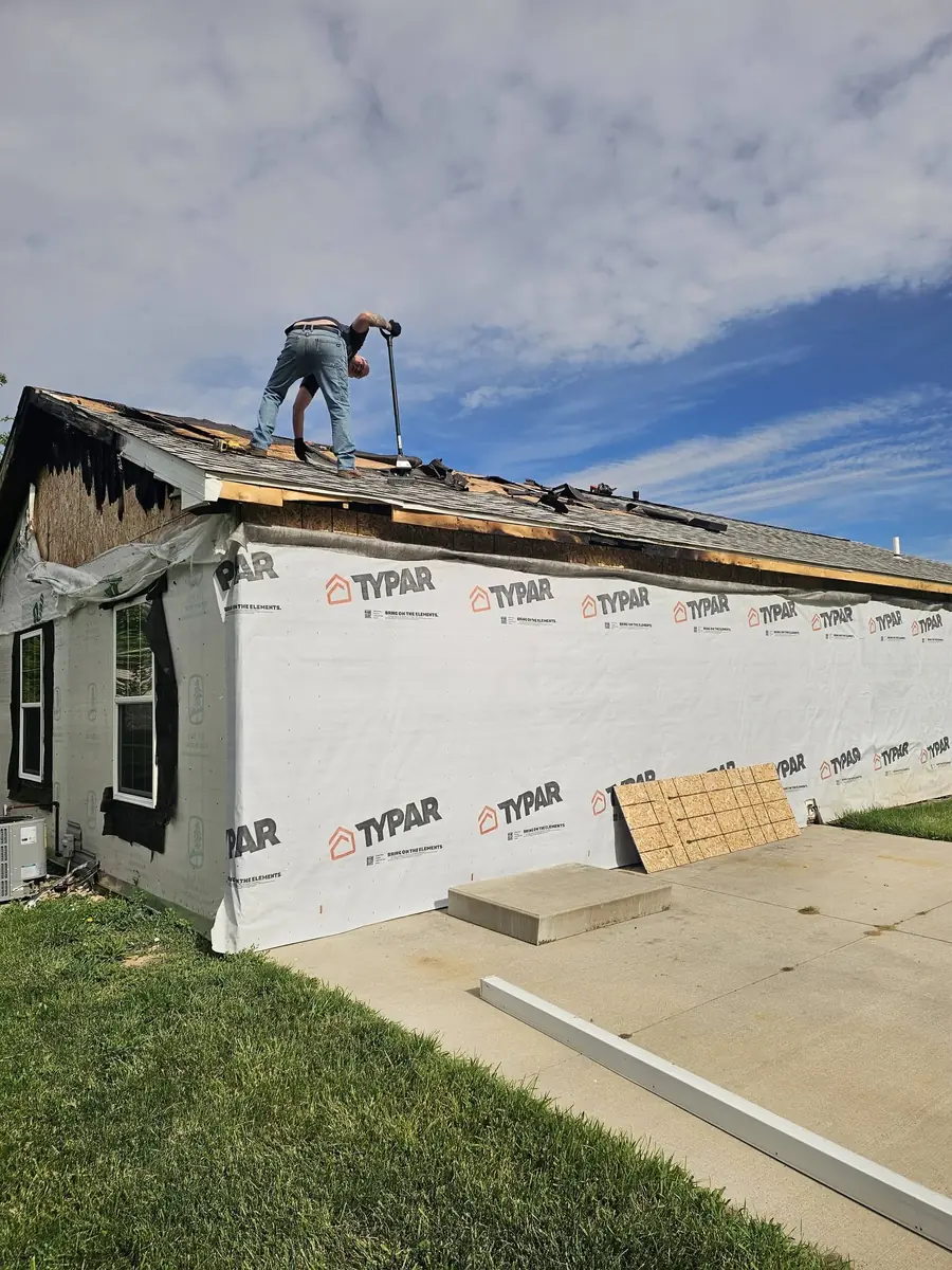 Roof replacement work underway on a residential building