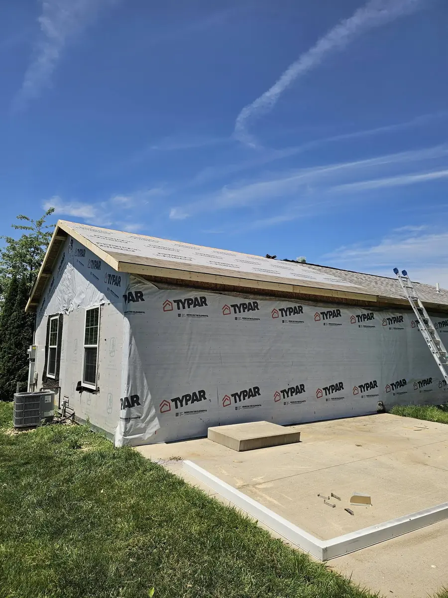 Residential addition protected with weather wrap before exterior finishing